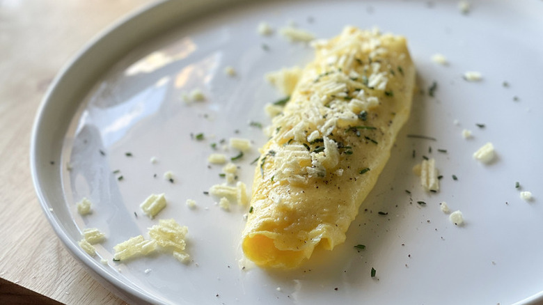 Boursin-filled omelet on plate, topped with crushed potato chips