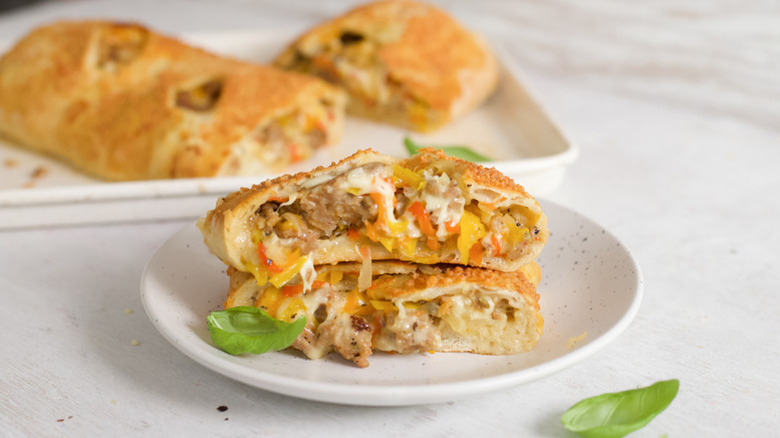 Slices of sausage- and cheese-stuffed bread on plate
