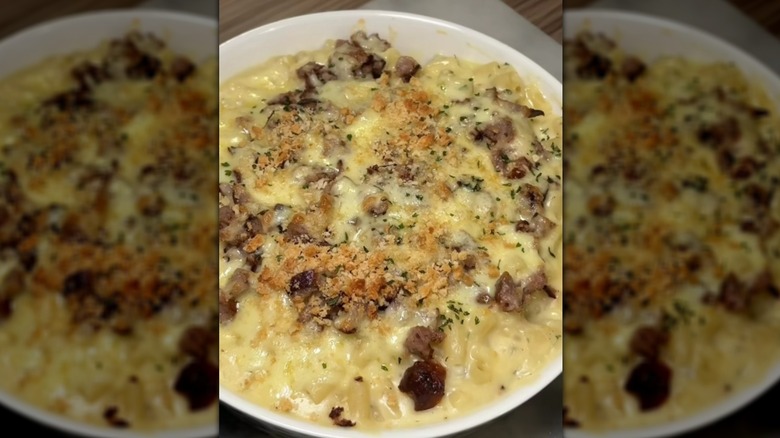 Sausage mac and cheese in white baking dish