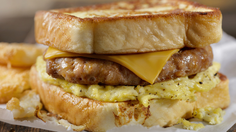 French toast sandwich with sausage, egg, and cheese on plate