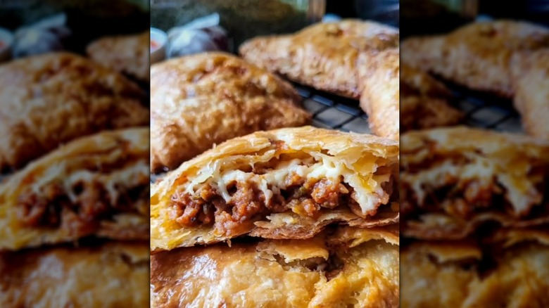 Close up of sausage- and cheese-filled hand pie on cooling rack