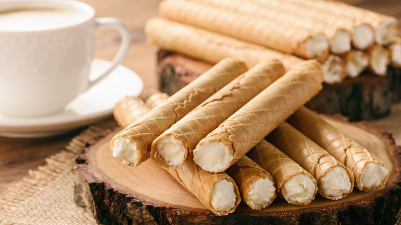 Whipped cream filled roller wafers on a wood plate
