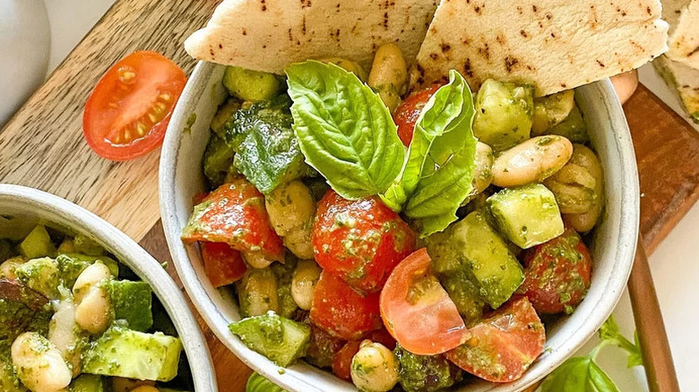 5-Ingredient White Bean and Pesto Salad in white bowl with pita chips