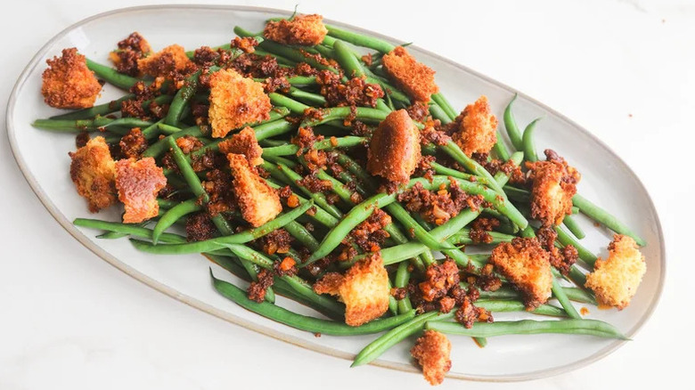 Green Bean Salad with 'Nduja Dressing on oblong white plate