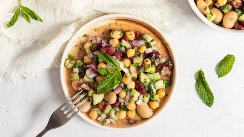 Herby Three Bean Salad in white bowl with mint
