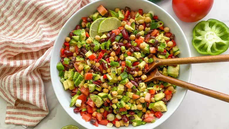 Jalapeno-Lime Three Bean Salad in white bowl with wooden spoons