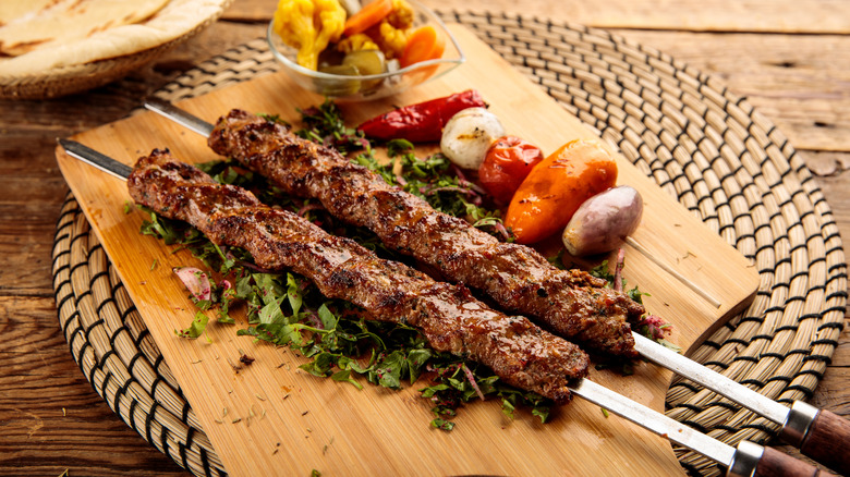 Several Turkish kebabs on a cutting board