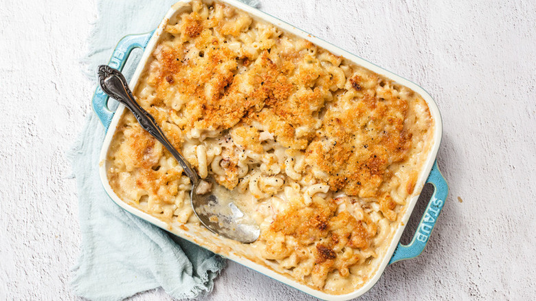 Lobster mac and cheese in baking dish with spoon