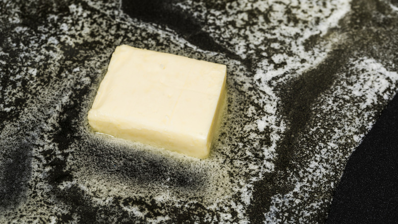 Close up of butter melting in pan