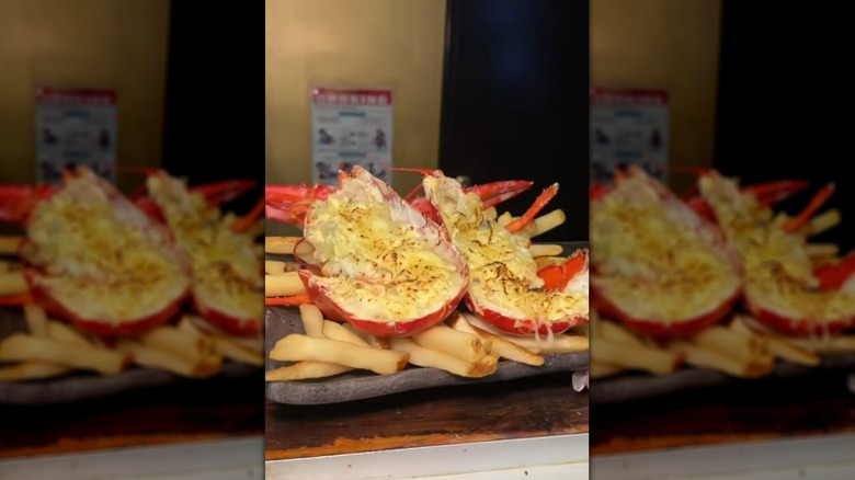 Cheesy halved lobster served on top of fries