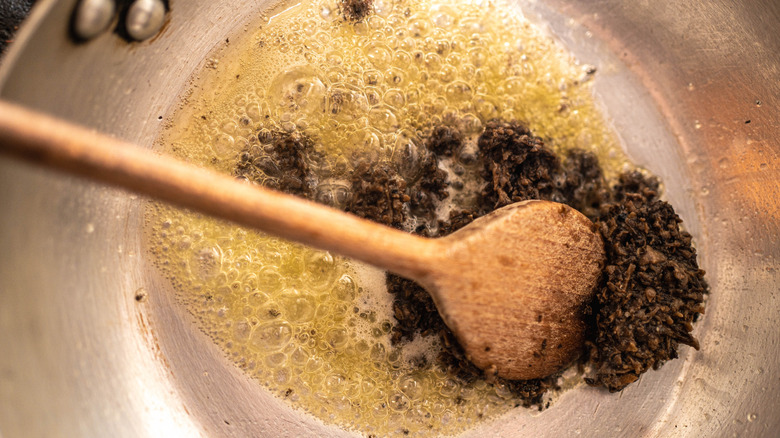 Stirring fresh black truffle into melted butter