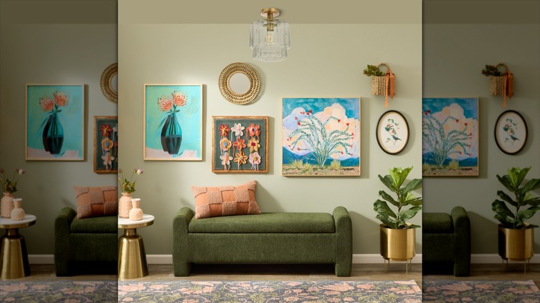 A beautifully decorated living rom with a glass ceiling lamp hanging over a green sofa
