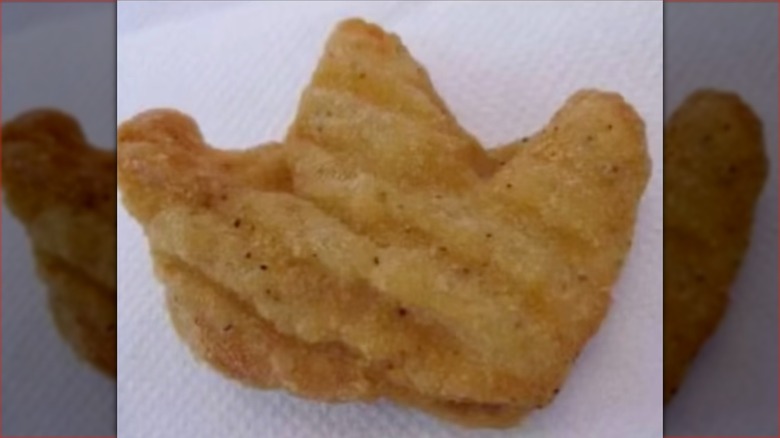Close-up shot of crown-shaped chicken nugget on napkin