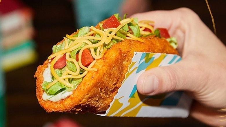 Hand holding Naked Chicken Chalupa in package