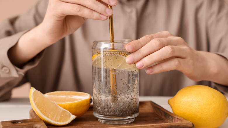 Woman stirring chia seeds into a glass of water
