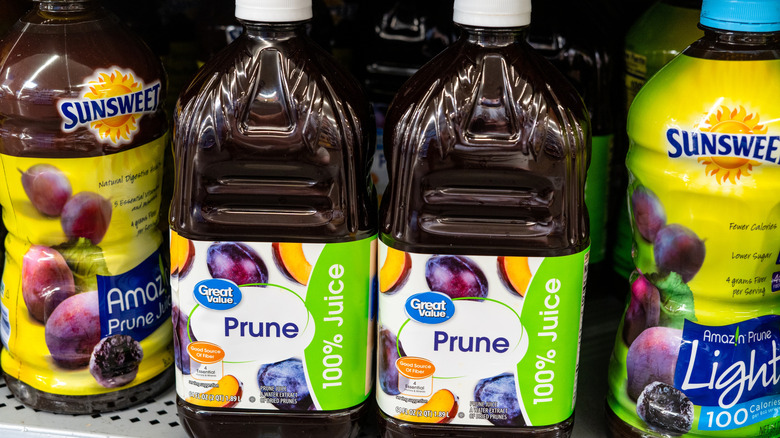 Bottles of prune juice on grocery store shelf