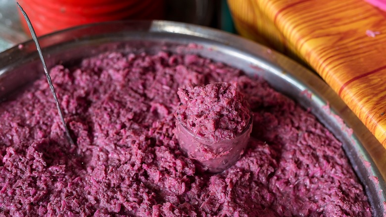 A bowl full of beet-colored bagoong, a type of Filipino shrimp or krill paste.