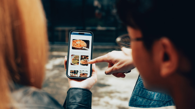 couple browsing food delivery app