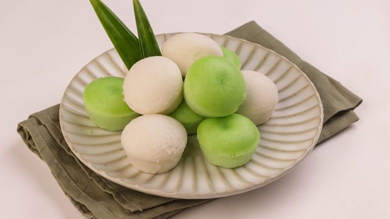 Green and white puto rice cakes on plate