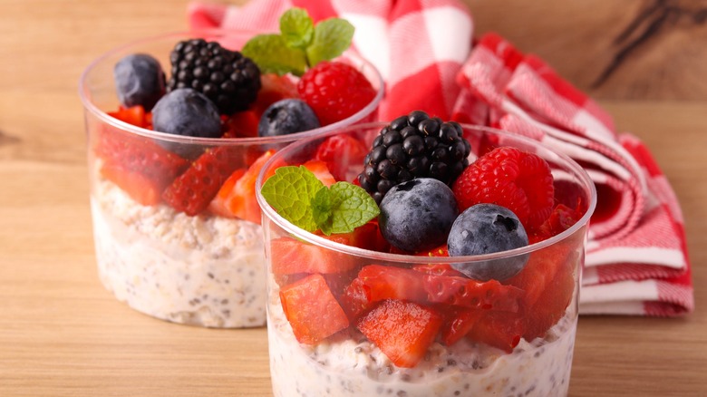 Two pots of overnight oats topped with fresh berries