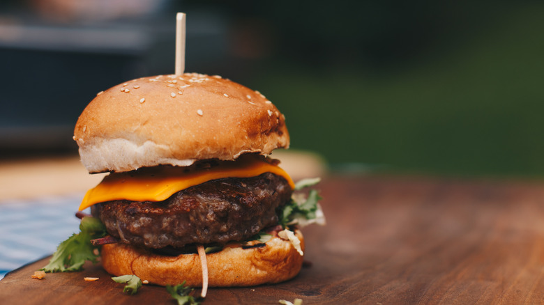 close up of hamburger on wooden board