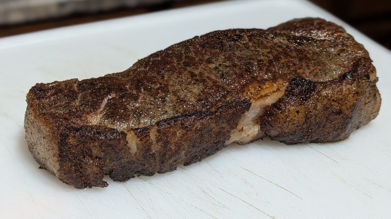 New York strip steak on a white plate