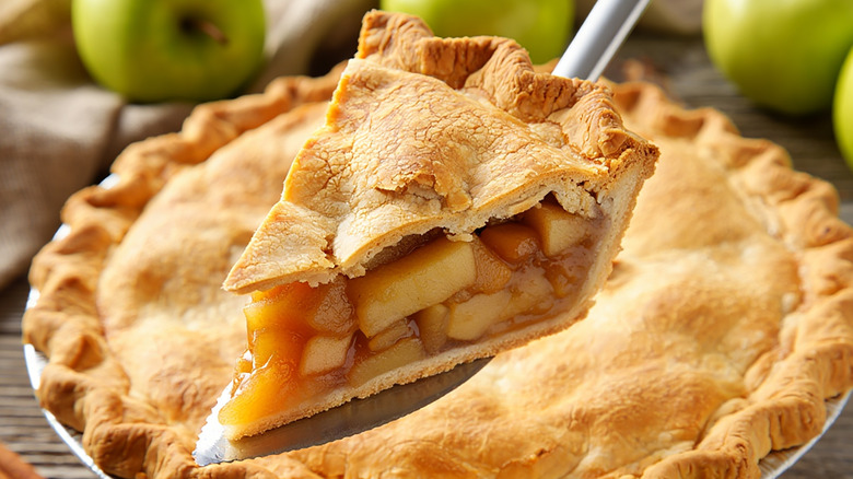close up of slice being removed from apple pie