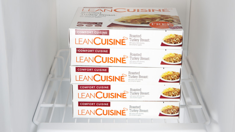 Five stacked boxes of Lean Cuisine meals in a freezer
