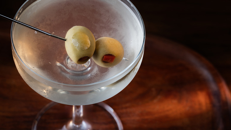 image of a dirty vodka martini on a table from above