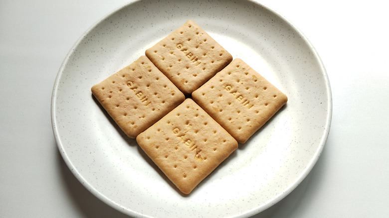 Four cabin biscuits on a round white plate