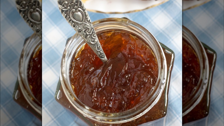 Mirrored image of open Oxford marmalade on blue and white table cloth