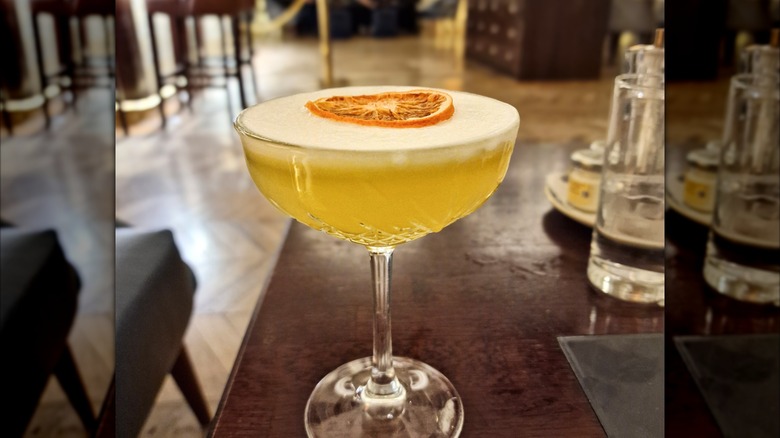 Mirrored image of Punch Romaine cocktail on bar table