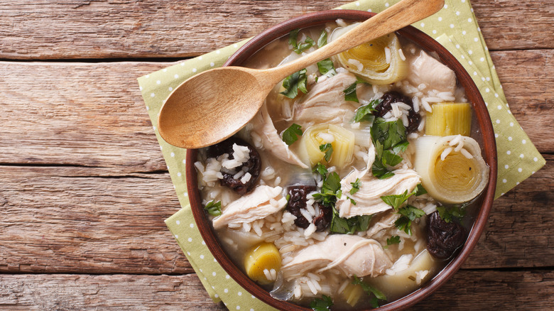 Scottish soup with leeks and prunes close up in a bowl on the table