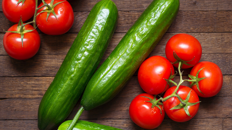 Tomatoes and cucumbers on a wooden table