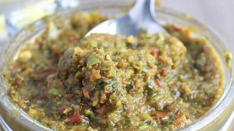 A spoon in a jar of Dominican sazón