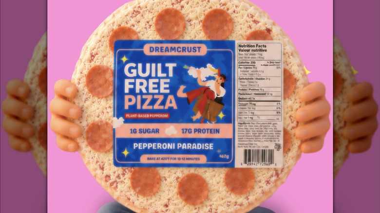 Person holding a Dreamcrust Pepperoni Paradise pizza