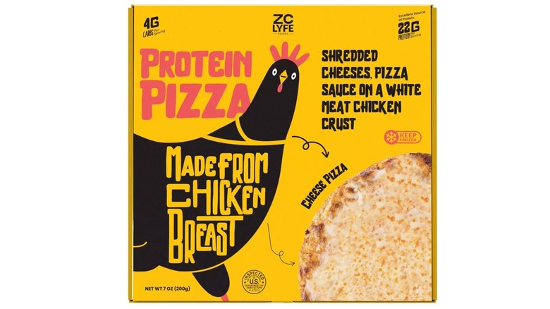 A person holding a ZC Lyfe brand frozen protein pizza with beef topping