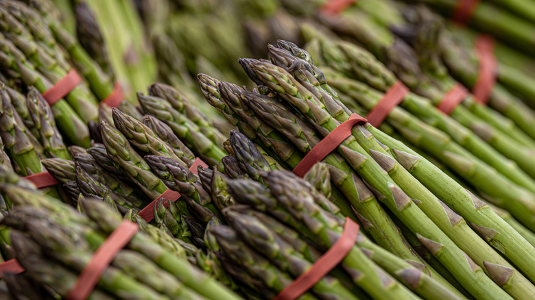 Pile of fresh asparagus with rubber bands