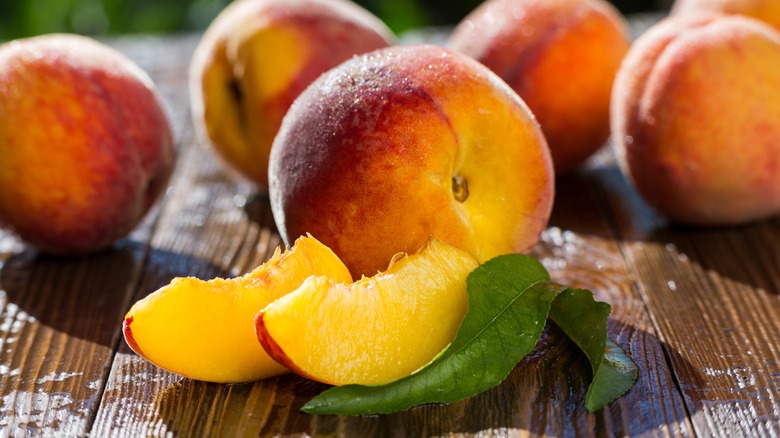 Freshly grown peaches whole and sliced