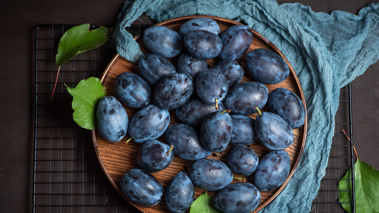 Bowl of fresh deep purple plums