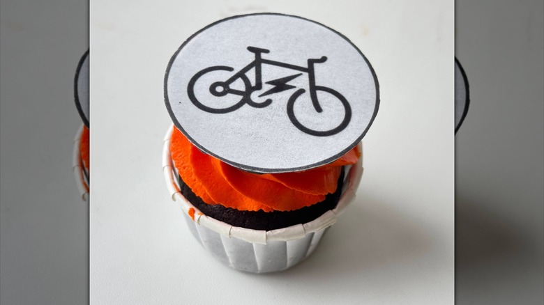 Cupcake with edible paper bicycle on top