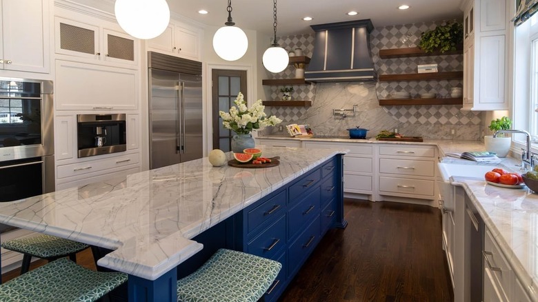 A spacious luxury kitchen with white quartzite counters and kitchen island
