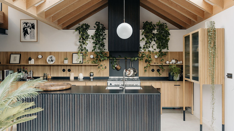 An eco-friendly kitchen featuring natural design materials and black slate Richlite counters and island