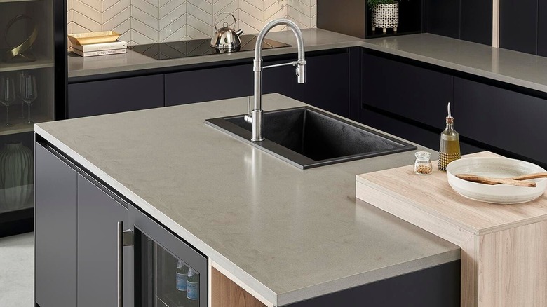 A small kitchen with solid surface countertops in a smooth gray stone design