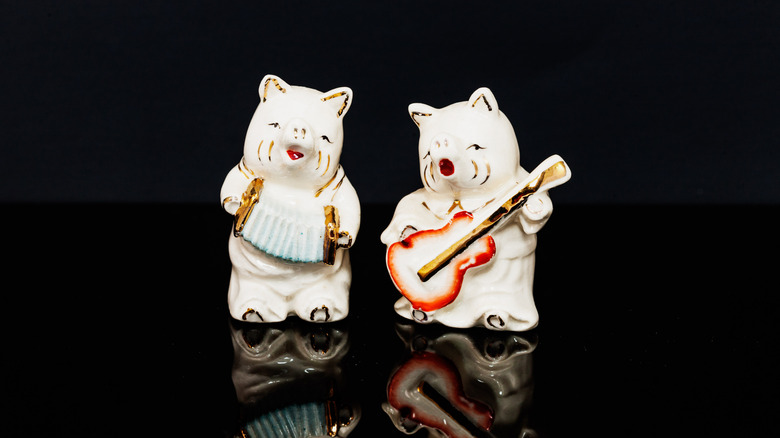 Ceramic figurine salt and pepper shakers shaped like instrument-playing pigs