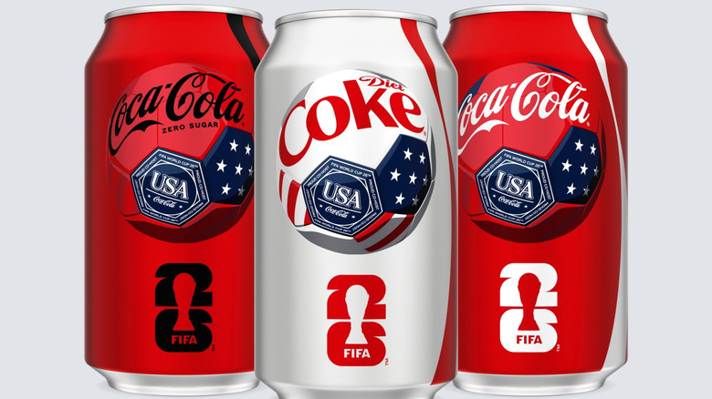 Cans of Coca-Cola Zero Sugar, Diet Coke, and Coca-Cola on gray background