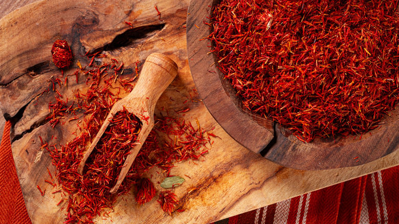 Saffron threads dispalyed in a wooden bowl and spoon