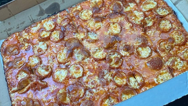 pepperoni and cheese pizza in a cardboard box