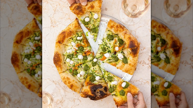 veggie pizza on a marble tabletop