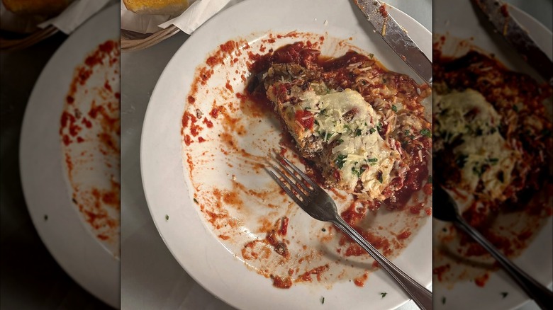 half eaten plate of baked stuffed eggplant